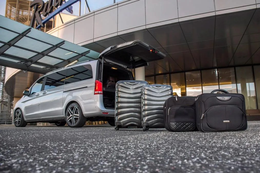 Mercedes v class van of TaxiWithBabySeat.com fleet loading many big luggage for big families